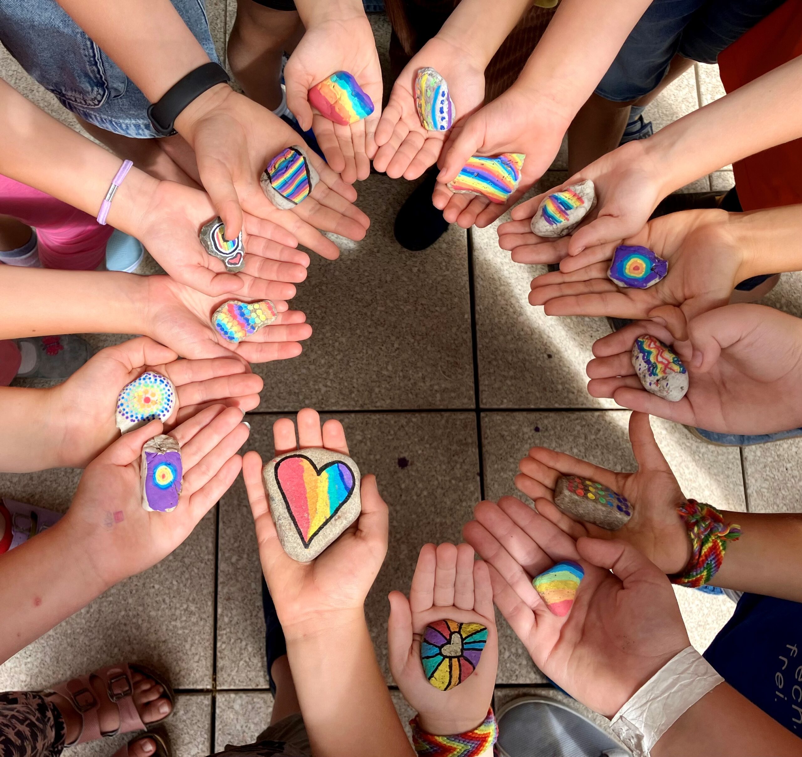 Evangelische Gemeinschaftsschule Weimar, Hände mit bunt bemalten Steinen