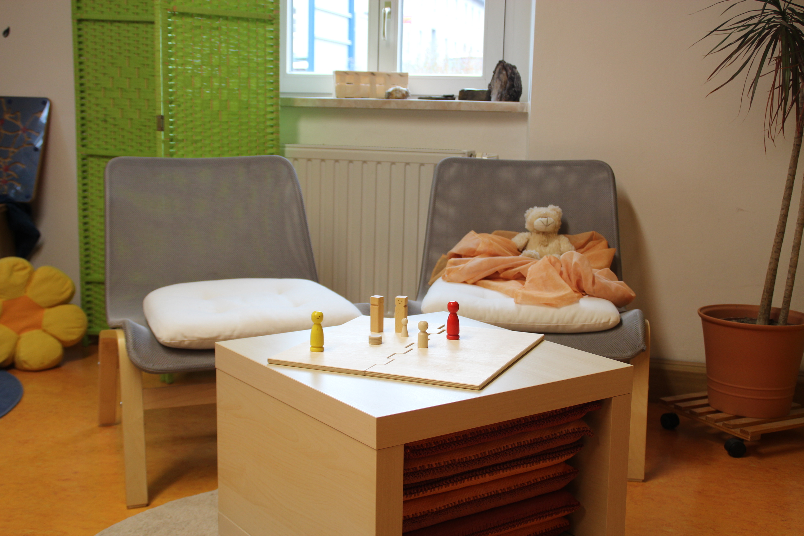 auf einen couchtisch steht ein Brettspiel, daneben zwei bequeme Sessel